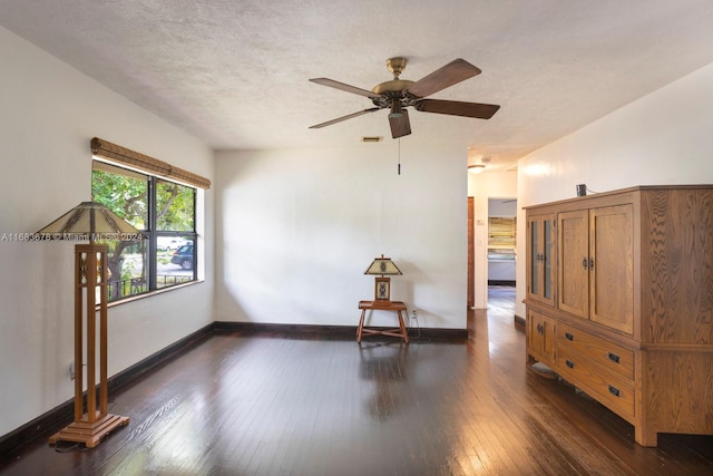 spare room featuring ceiling fan, a textured ceiling, and dark hardwood / wood-style flooring