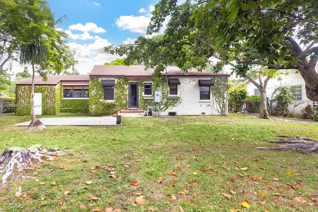 back of house with a lawn