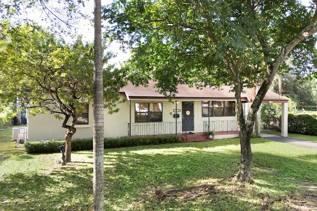 single story home featuring covered porch and a front lawn