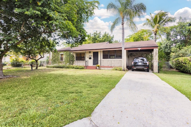 single story home featuring covered porch, a carport, and a front yard