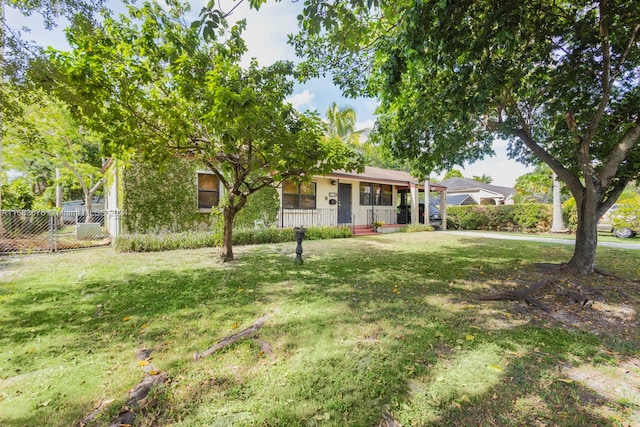 view of front facade with covered porch and a front lawn