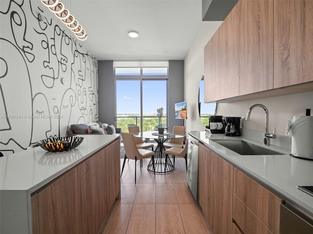 3900 Biscayne Blvd Unit N-1211, Miami, FL 33137 - kitchen with modern cabinets, a sink, brown cabinetry, light countertops, and expansive windows
