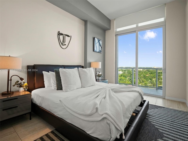 bedroom featuring light tile patterned floors and access to exterior