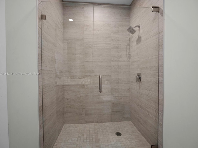 bathroom with a shower with shower door