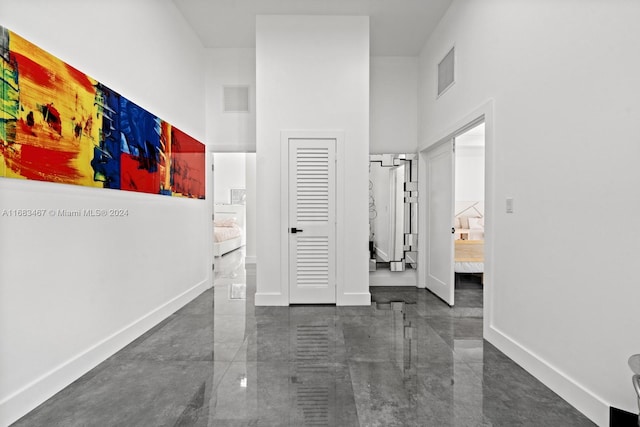 corridor featuring a towering ceiling