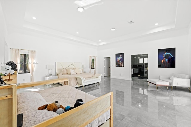 bedroom with a raised ceiling and a towering ceiling