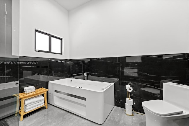 bathroom with toilet, tile walls, and a tub