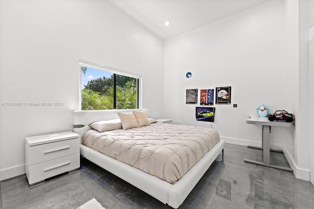 bedroom with high vaulted ceiling