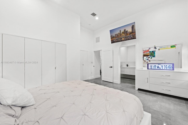 bedroom with a closet and a towering ceiling