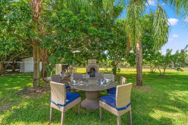 view of yard with an outdoor stone fireplace