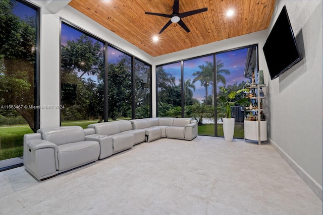 unfurnished sunroom featuring ceiling fan and wooden ceiling