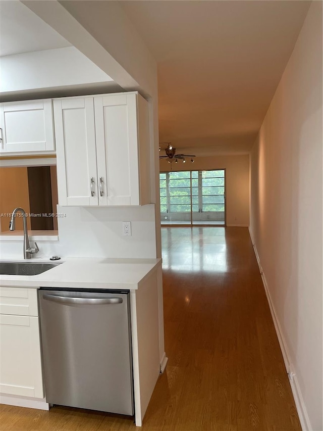 kitchen featuring dishwasher, white cabinets, sink, hardwood / wood-style flooring, and ceiling fan