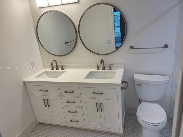 bathroom with tile patterned floors, vanity, and toilet