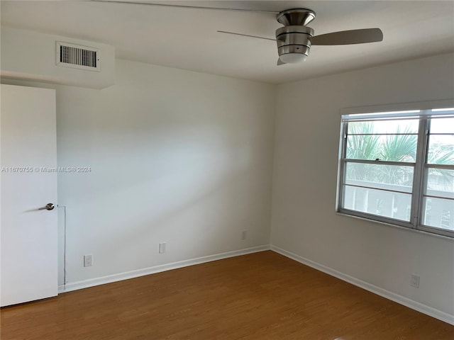 empty room with ceiling fan and dark wood-type flooring