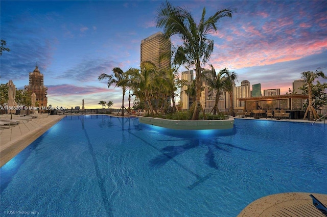 view of pool at dusk