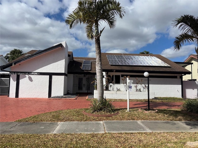 view of front of property with solar panels