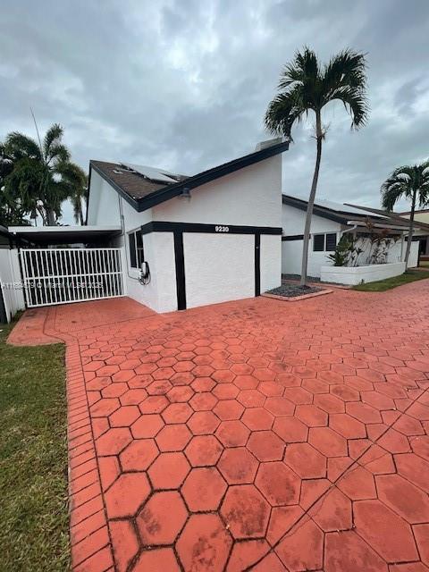 9230 SW 100th Ave Rd, Miami, FL 33176 - full bathroom with a tile shower, toilet, a bidet, and tile walls