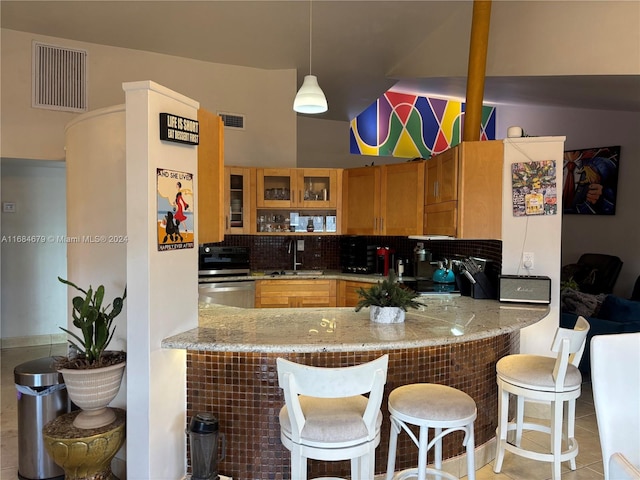 kitchen featuring decorative light fixtures, dishwasher, kitchen peninsula, and sink