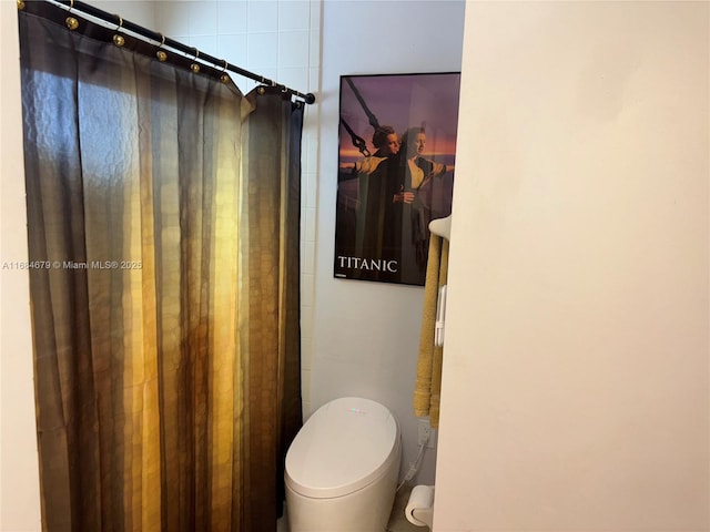 full bathroom featuring toilet and a shower with shower curtain
