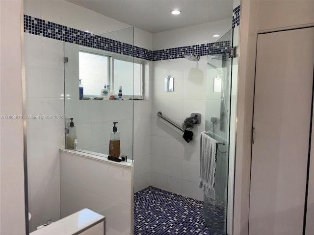 bathroom with recessed lighting and walk in shower