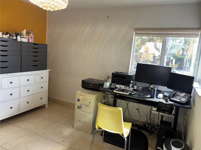 home office featuring light tile patterned floors and an inviting chandelier