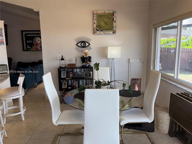 tiled dining space featuring plenty of natural light