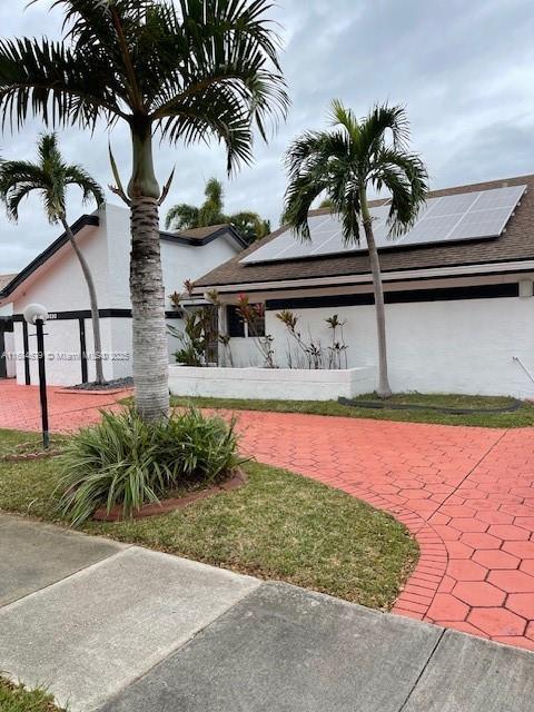 9230 SW 100th Ave Rd, Miami, FL 33176 - exterior space with solar panels and stucco siding