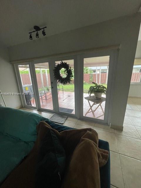 interior space featuring light tile patterned floors and french doors