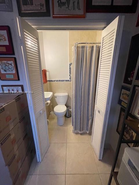 bathroom featuring toilet and tile patterned floors