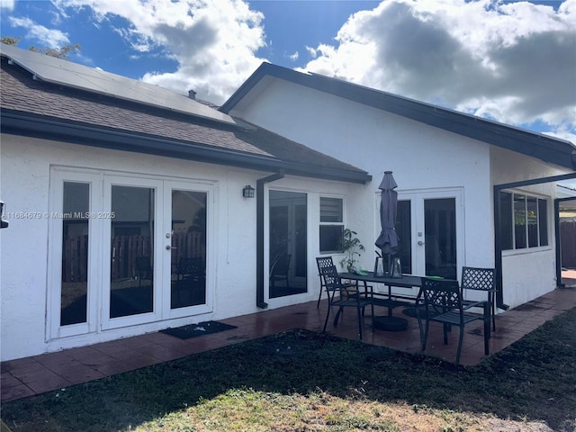9230 SW 100th Ave Rd, Miami, FL 33176 - back of property featuring french doors, a patio, solar panels, stucco siding, and a shingled roof