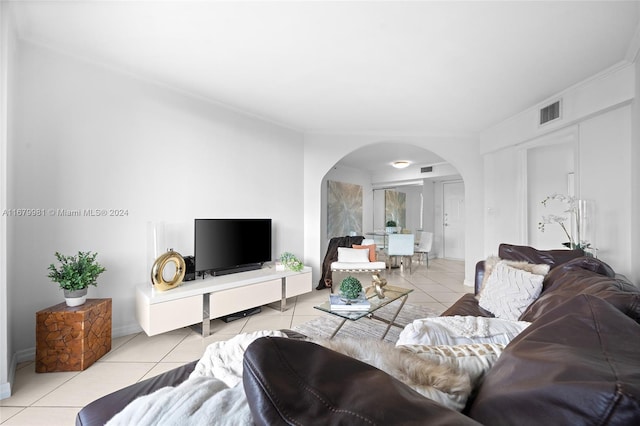 living room featuring ornamental molding and light tile patterned floors