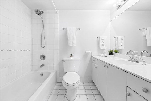 full bathroom with vanity, tiled shower / bath combo, toilet, and tile patterned flooring