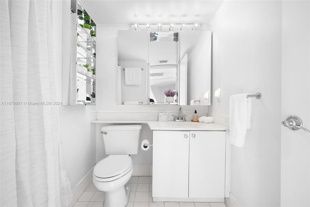 bathroom featuring vanity, toilet, and tile patterned flooring