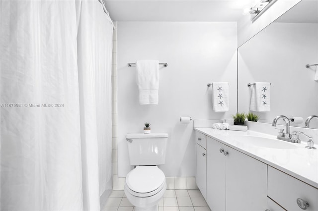 bathroom featuring vanity, toilet, and tile patterned flooring