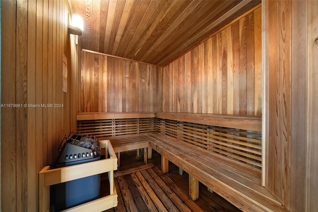 view of sauna with wooden walls, hardwood / wood-style flooring, and wooden ceiling