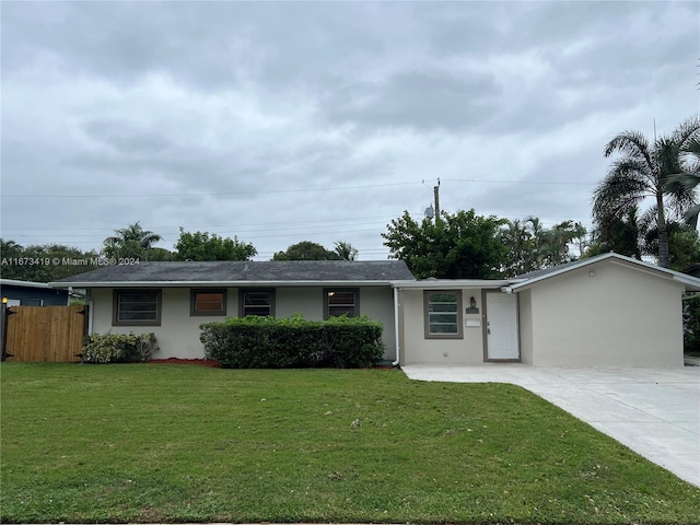 single story home featuring a front lawn