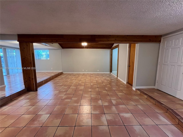 basement featuring a textured ceiling and light tile patterned floors