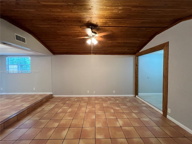 tiled empty room featuring lofted ceiling, wooden ceiling, and ceiling fan