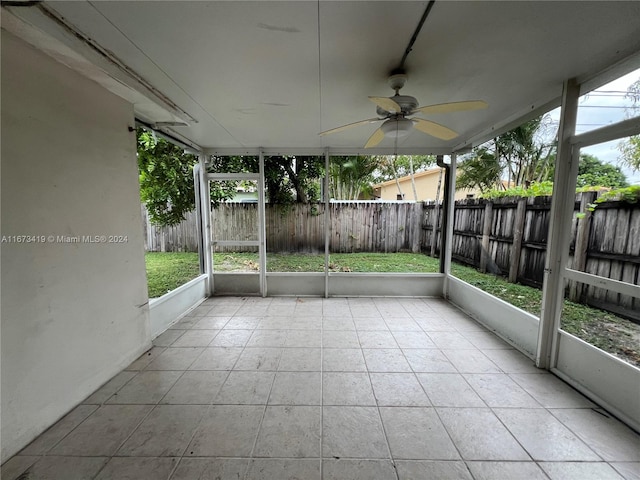 unfurnished sunroom featuring ceiling fan