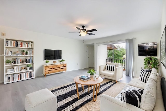 living room featuring ceiling fan and light wood-type flooring