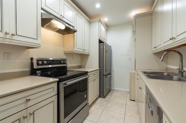 kitchen featuring appliances with stainless steel finishes, light tile patterned floors, and sink