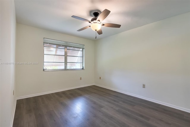 unfurnished room with ceiling fan and dark wood-type flooring