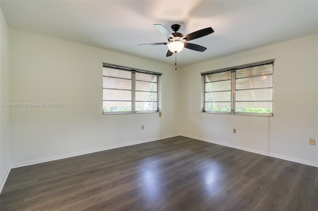 empty room with dark hardwood / wood-style flooring and ceiling fan