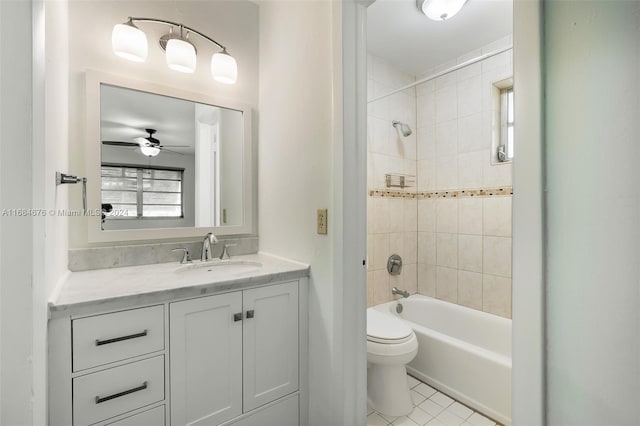 full bathroom featuring ceiling fan, tiled shower / bath combo, tile patterned flooring, toilet, and vanity