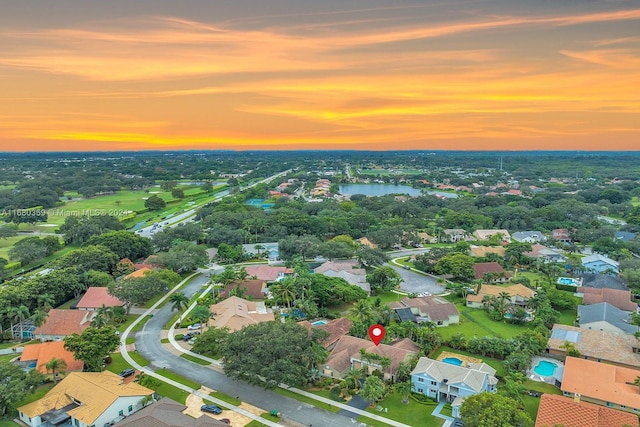 aerial view at dusk with a water view