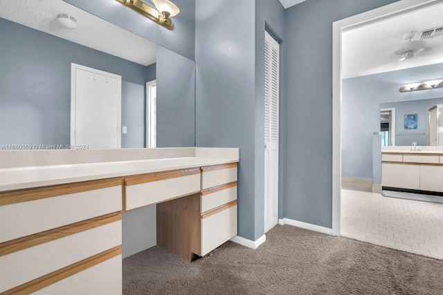 bathroom with vanity and a textured ceiling