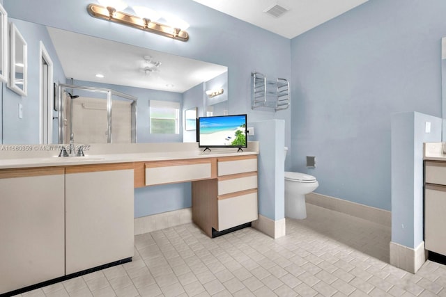 bathroom with vanity, tile patterned flooring, toilet, and an enclosed shower