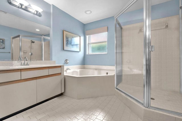 bathroom with vanity, tile patterned floors, and separate shower and tub