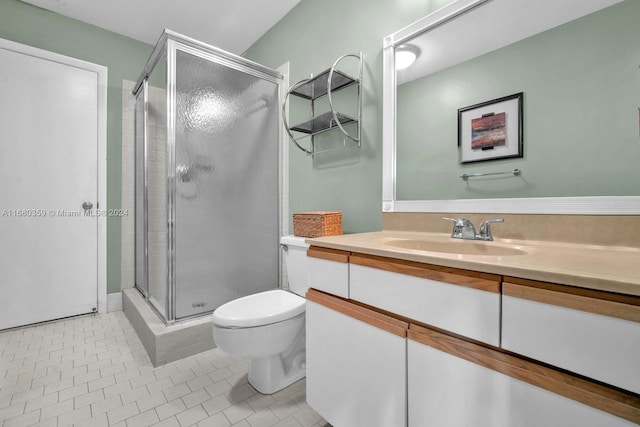 bathroom with vanity, toilet, tile patterned flooring, and a shower with door