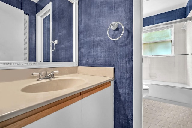 full bathroom featuring vanity, tiled shower / bath, toilet, and tile patterned flooring